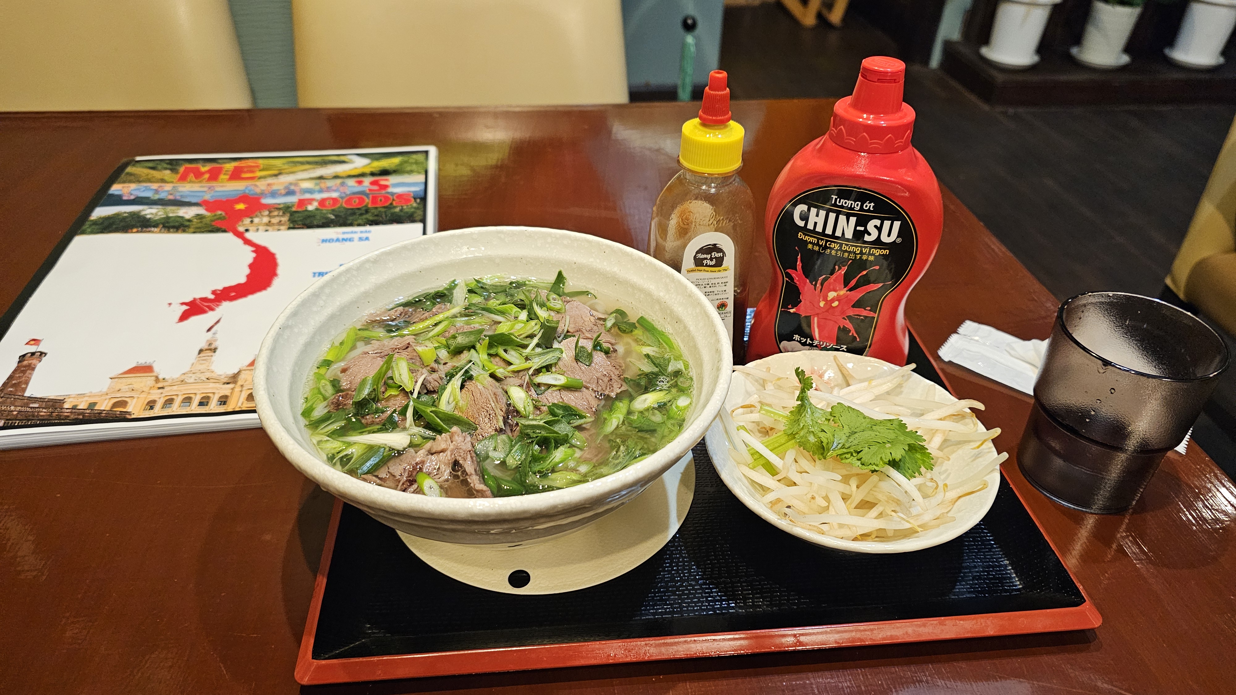 A bowl of Vietnamese pho with fresh herbs