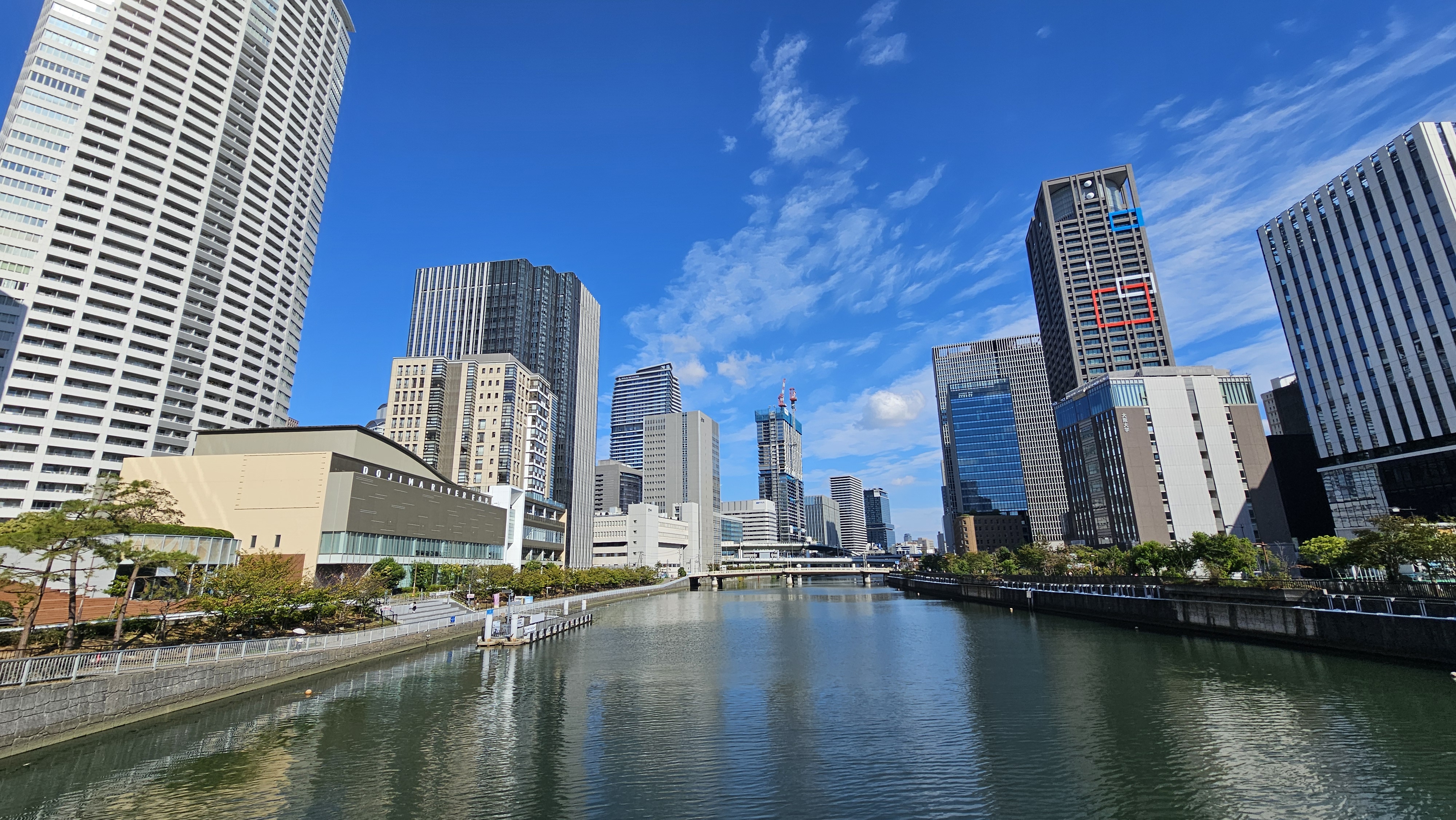 Osaka riverside and skyline under a blue sky